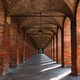 Symmetrical brick arcade in Sabbioneta, Italy, with long perspective Symmetrical brick arcade in Sabbioneta, Italy, with long perspective - PhotoDune Item for Sale