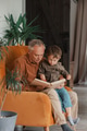 grandfather reading a book with grandson at home grandfather reading a book with grandson at home - PhotoDune Item for Sale