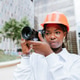 Serious black female photographer using camera on street Serious black female photographer using camera on street - PhotoDune Item for Sale
