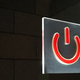Red power symbol on a transparent surface on a wall background Stock ...