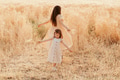 Two sisters little girls wear casual dresses having fun in wheat field. Kids in motion. Yellow color Two sisters little girls wear casual dresses having fun in wheat field. Kids in motion. Yellow color - PhotoDune Item for Sale