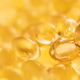 Banner closeup of oil gel capsules on yellow background. Banner closeup of oil gel capsules on yellow background. - PhotoDune Item for Sale