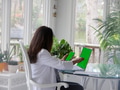 Latino Hispanic Woman in workspace using laptop & mobile device with mockup friendly green screen Latino Hispanic Woman in workspace using laptop & mobile device with mockup friendly green screen - PhotoDune Item for Sale