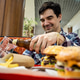 man eating burger fast food and drinking beer alone in the open area restaurant in shopping mall man eating burger fast food and drinking beer alone in the open area restaurant in shopping mall - PhotoDune Item for Sale