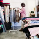 blurred woman in background. Rolls of fabrics in dressmaker's Atelier. Small business. fabrics shop blurred woman in background. Rolls of fabrics in dressmaker's Atelier. Small business. fabrics shop - PhotoDune Item for Sale