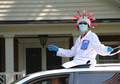 A neighbor wearing a Covid19 costume and waving the flag during the July 4th cars parade. A neighbor wearing a Covid19 costume and waving the flag during the July 4th cars parade. - PhotoDune Item for Sale