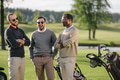 happy multiethnic golfers spending time together in golf course happy multiethnic golfers spending time together in golf course - PhotoDune Item for Sale