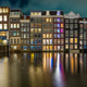 Amsterdam at night. Colorful houses and canal water Amsterdam at night. Colorful houses and canal water - PhotoDune Item for Sale