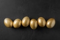 Chicken colored golden eggs on black. Easter dark concept. View from above. Chicken colored golden eggs on black. Easter dark concept. View from above. - PhotoDune Item for Sale