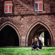Young Woman Sitting on Grass Near Historic Stone Building Young Woman Sitting on Grass Near Historic Stone Building - PhotoDune Item for Sale