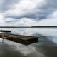 Lake of Soustons reflecting a cloudy sky and wooden docks Lake of Soustons reflecting a cloudy sky and wooden docks - PhotoDune Item for Sale