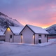 Sunrise over Norwegian cottages and snowy mountains in Torsken on Senja island, Norway in winter. Sunrise over Norwegian cottages and snowy mountains in Torsken on Senja island, Norway in winter. - PhotoDune Item for Sale