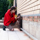 Worker installing house plinth with metal sheets during construction works Worker installing house plinth with metal sheets during construction works - PhotoDune Item for Sale