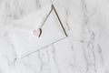 Minimalistic mockup friendly white envelope with pastel heart sealing it on marble surface Minimalistic mockup friendly white envelope with pastel heart sealing it on marble surface - PhotoDune Item for Sale