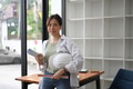 Confident female construction engineer holding safety helmet and looking at camera. Confident female construction engineer holding safety helmet and looking at camera. - PhotoDune Item for Sale