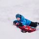 Happy boy on a snow tube in winter Happy boy on a snow tube in winter - PhotoDune Item for Sale