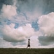 A boy walking across the top of a hill. A boy walking across the top of a hill. - PhotoDune Item for Sale