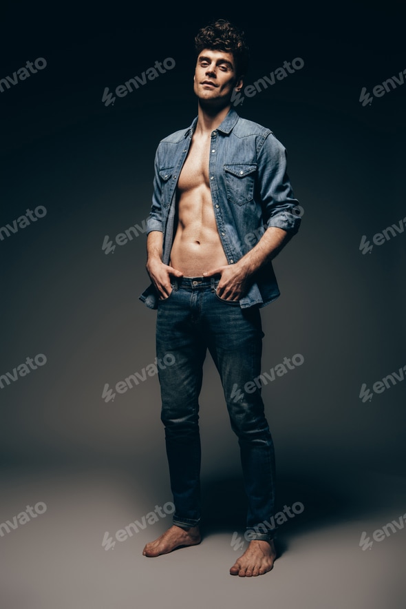 barefoot sexy man posing in jeans clothes on dark grey Stock Photo by LightFieldStudios barefoot sexy man posing in jeans clothes on dark grey Stock Photo by LightFieldStudios