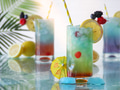 Colorful summer tropical cocktail drinks on glass surface with fresh citrus fruits Colorful summer tropical cocktail drinks on glass surface with fresh citrus fruits - PhotoDune Item for Sale