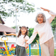 Old woman grandmother and kid girl granddaughter holding hand and standing in the park's playground. Old woman grandmother and kid girl granddaughter holding hand and standing in the park's playground. - PhotoDune Item for Sale