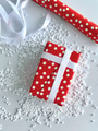 Flat lay overhead of gift wrapped in red with white polka dots wrapping paper with white ribbon. Flat lay overhead of gift wrapped in red with white polka dots wrapping paper with white ribbon. - PhotoDune Item for Sale