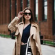 Young pretty beautiful woman in trench coat and sunglasses Young pretty beautiful woman in trench coat and sunglasses - PhotoDune Item for Sale