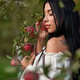 Gorgeous tattooed woman leaning on apple tree branch in fall. Gorgeous tattooed woman leaning on apple tree branch in fall. - PhotoDune Item for Sale