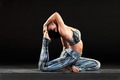 Supple fit woman doing a king pigeon yoga pose Supple fit woman doing a king pigeon yoga pose - PhotoDune Item for Sale