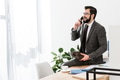 businessman talking by stationary telephone in office and sitting on table businessman talking by stationary telephone in office and sitting on table - PhotoDune Item for Sale