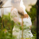 Pregnant woman in white dress surrounded by lush garden greenery Pregnant woman in white dress surrounded by lush garden greenery - PhotoDune Item for Sale