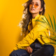 A teenage girl sitting on a chair on a yellow background A teenage girl sitting on a chair on a yellow background - PhotoDune Item for Sale