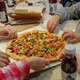 Food delivery, pizza on the table. Friends take the delivered food with their hands. A fun party. Food delivery, pizza on the table. Friends take the delivered food with their hands. A fun party. - PhotoDune Item for Sale
