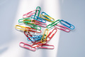 Colored paper clips close-up on a white background Colored paper clips close-up on a white background - PhotoDune Item for Sale
