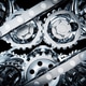 Metallic gears and chains rotating on black background Metallic gears and chains rotating on black background - PhotoDune Item for Sale