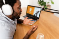 African man recording a podcast using microphone and laptop from his home studio African man recording a podcast using microphone and laptop from his home studio - PhotoDune Item for Sale