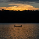 Sunset and people boating in the lake. Sunset and people boating in the lake. - PhotoDune Item for Sale