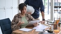 Team of architects working on construction plans in modern office. Team of architects working on construction plans in modern office. - PhotoDune Item for Sale