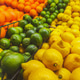 Three rows of citrus fruits cascading in market display with oranges, green limes, and yellow lemons Three rows of citrus fruits cascading in market display with oranges, green limes, and yellow lemons - PhotoDune Item for Sale