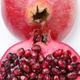 Halved pomegranate slices close up with seeds. Halved pomegranate slices close up with seeds. - PhotoDune Item for Sale