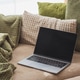 Laptop on Cozy Sofa with Textured Pillows and Blanket. Relaxed Home Workspace Laptop on Cozy Sofa with Textured Pillows and Blanket. Relaxed Home Workspace - PhotoDune Item for Sale
