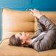 Beautiful woman lying on the sofa in her office, smiling and texting on her phone. Beautiful woman lying on the sofa in her office, smiling and texting on her phone. - PhotoDune Item for Sale