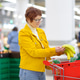 Beautiful red-haired senior lady is choosing fresh organic bananas in a food store Beautiful red-haired senior lady is choosing fresh organic bananas in a food store - PhotoDune Item for Sale