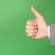 a hand showing a thumbs up or like gesture on green background a hand showing a thumbs up or like gesture on green background - PhotoDune Item for Sale