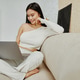 Attractive asian woman using laptop computer while sitting on a couch at home. Attractive asian woman using laptop computer while sitting on a couch at home. - PhotoDune Item for Sale