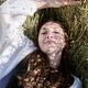 Young woman lying in sunlit rye field with shadow patterns on face Young woman lying in sunlit rye field with shadow patterns on face - PhotoDune Item for Sale