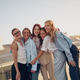 A Joyful Group of Friends Embracing Together in the Warm Sunshine Outdoors and Laughing A Joyful Group of Friends Embracing Together in the Warm Sunshine Outdoors and Laughing - PhotoDune Item for Sale