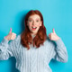 Amazed redhead girl in sweater, showing thumbs up and praising product, looking at camera amazed Amazed redhead girl in sweater, showing thumbs up and praising product, looking at camera amazed - PhotoDune Item for Sale