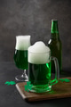 Patrick's day traditional green beer and bottle on black background. Patrick's day traditional green beer and bottle on black background. - PhotoDune Item for Sale
