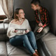 Child and parent playing Together on a Sofa Using Electronic Devices. Child and parent playing Together on a Sofa Using Electronic Devices. - PhotoDune Item for Sale