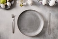 Easter festive table setting with gray plate, spring flowers and green colorful eggs. Easter festive table setting with gray plate, spring flowers and green colorful eggs. - PhotoDune Item for Sale